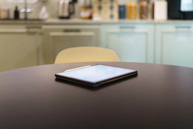 A sleek tablet resting on a modern kitchen table with a blurred background.
