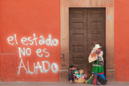 A colorful street vendor scene with political graffiti in Querétaro, Mexico.