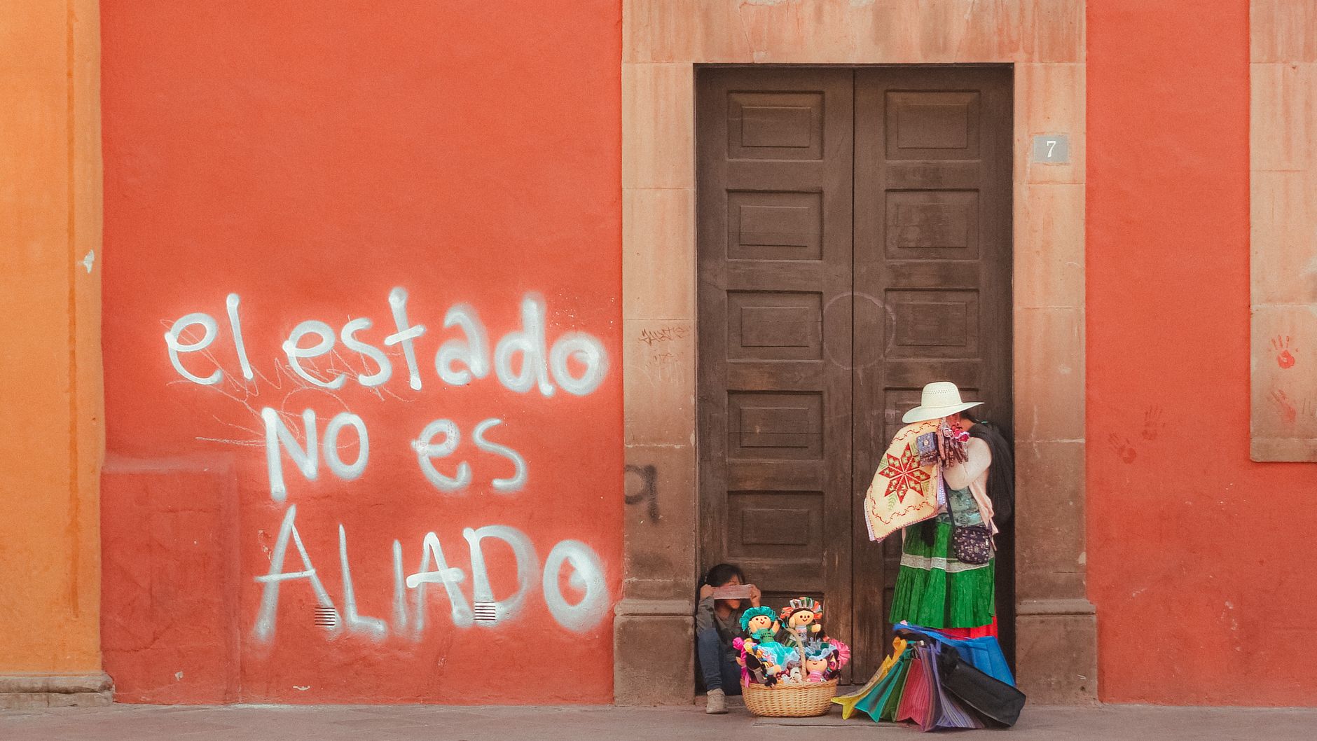 A colorful street vendor scene with political graffiti in Querétaro, Mexico.