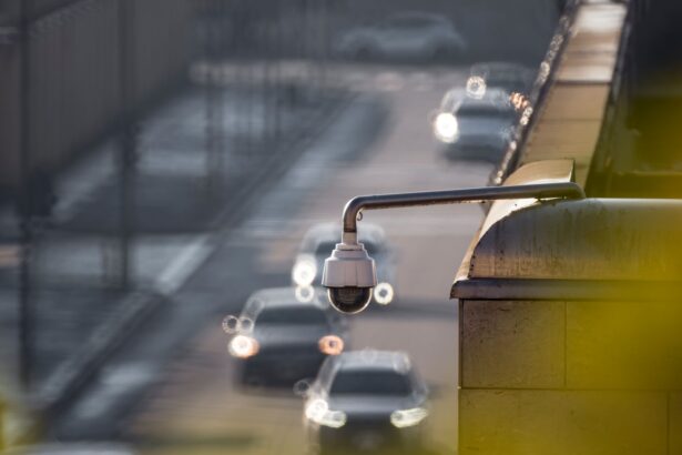 CCTV camera monitoring city traffic on a busy road with blurred vehicles in the background.