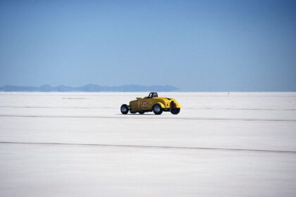 Vintage yellow hot rod racing on the Bonneville Salt Flats. High speed adventure.