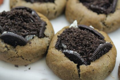 Close-up of baked cookies topped with Oreo crumble, a sweet and enticing treat.