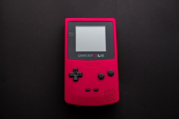 Close-up of a red Nintendo Game Boy Color on a dark backdrop, showcasing retro gaming nostalgia.