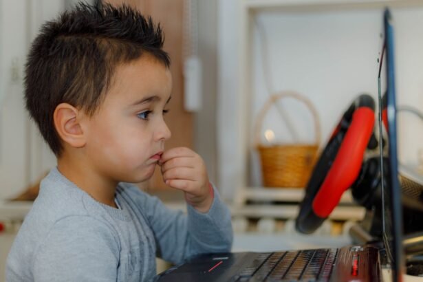 A young child focused on a laptop for educational purposes at home.