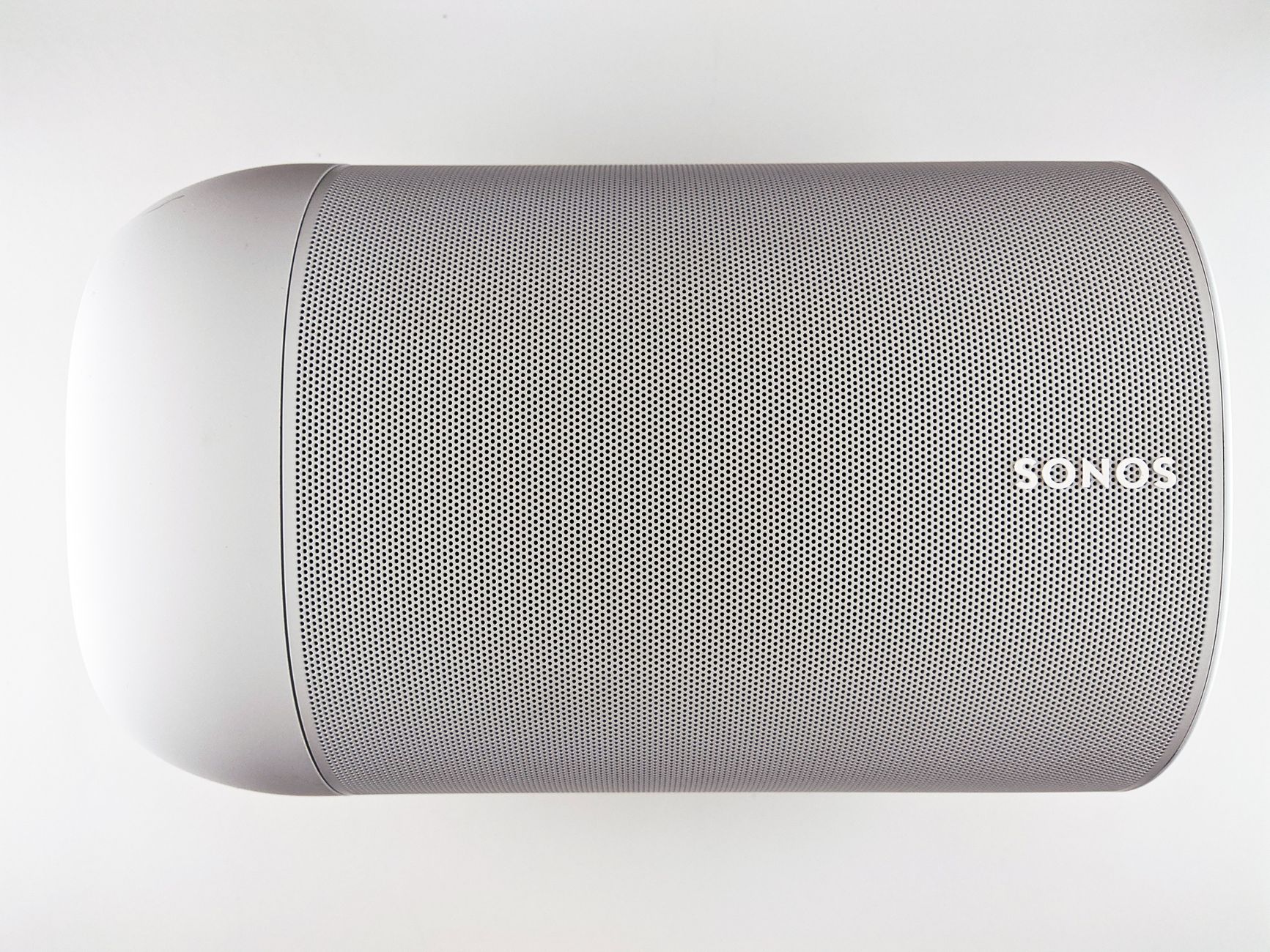 Top view of a sleek wireless speaker with a minimalistic design.