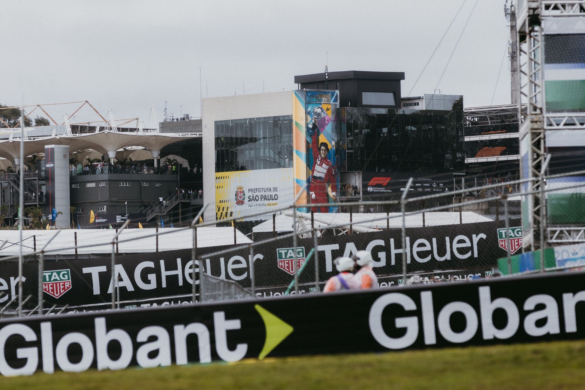 View of the São Paulo race track with advertising banners and crowd, ideal for motorsport themes.