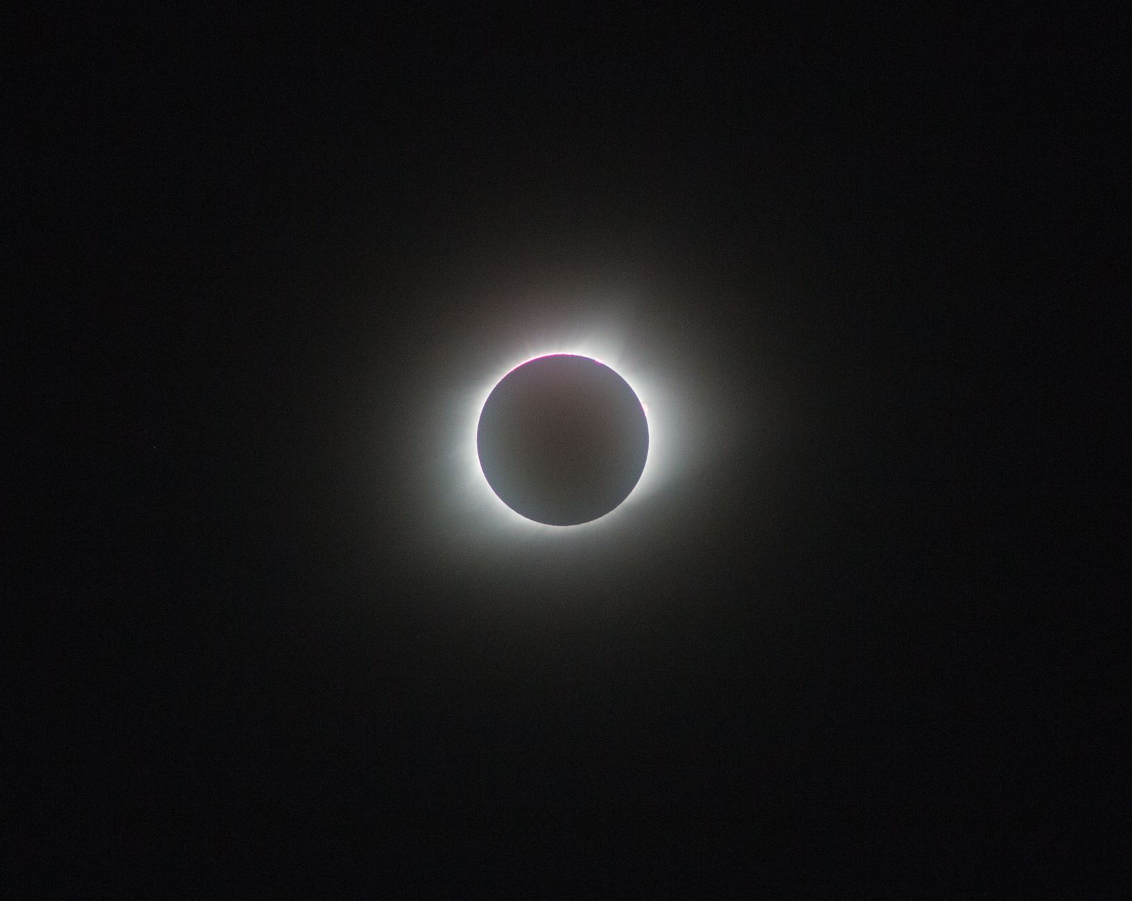 A breathtaking view of a full solar eclipse, showcasing the sun's corona.