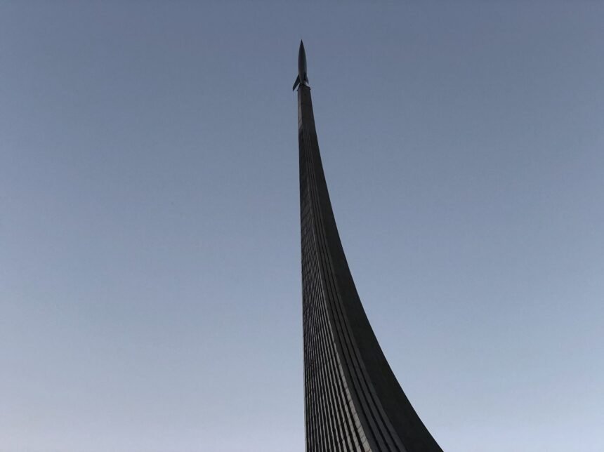 Monument to the Conquerors of Space in Moscow, captured from a low angle showing its sleek architecture against the sky.