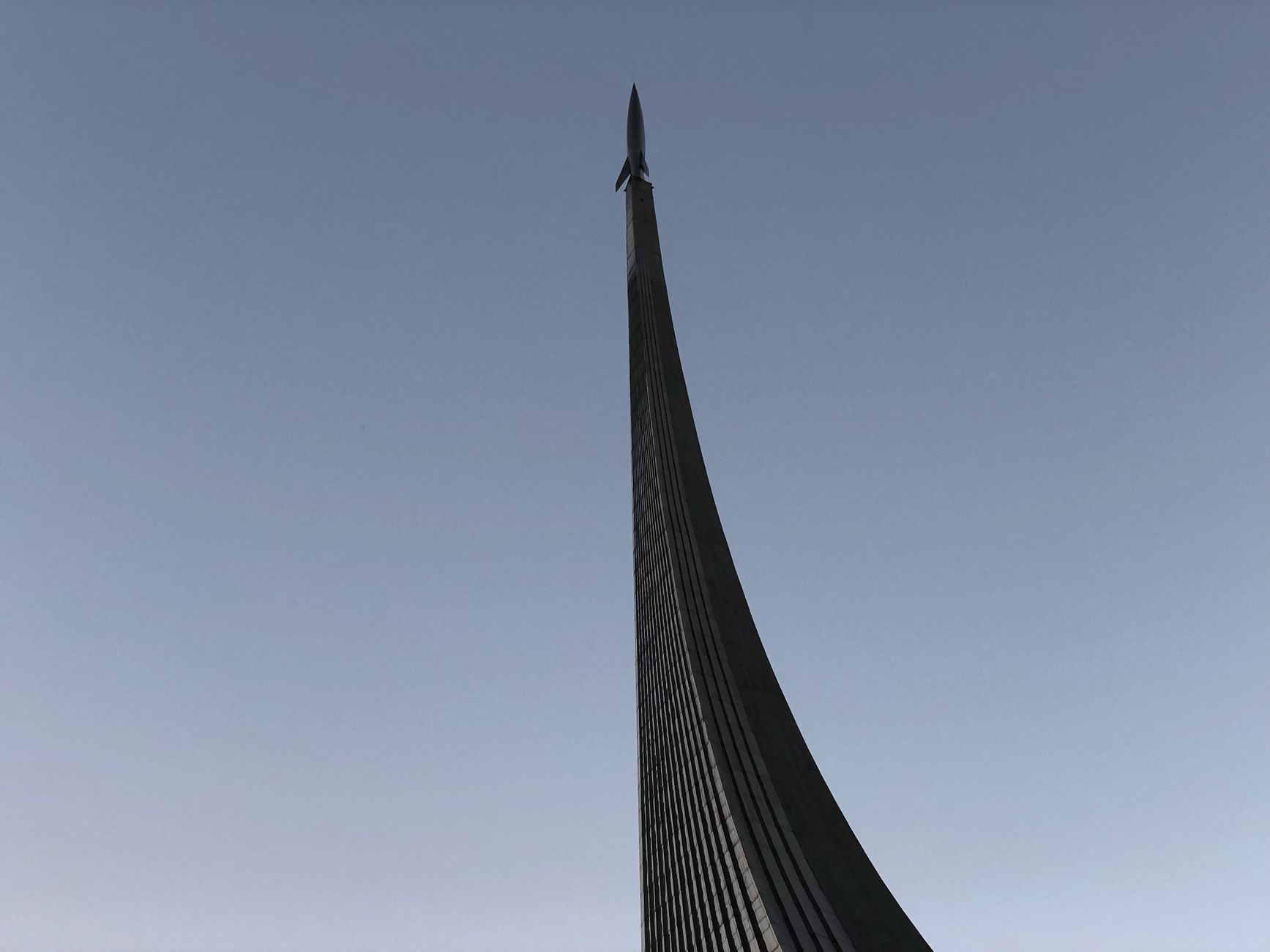 Monument to the Conquerors of Space in Moscow, captured from a low angle showing its sleek architecture against the sky.
