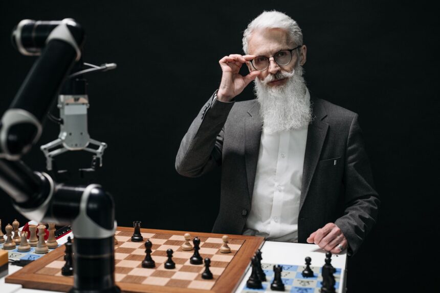 Senior man strategizing in a chess game against a robot, showcasing AI in leisure activities.
