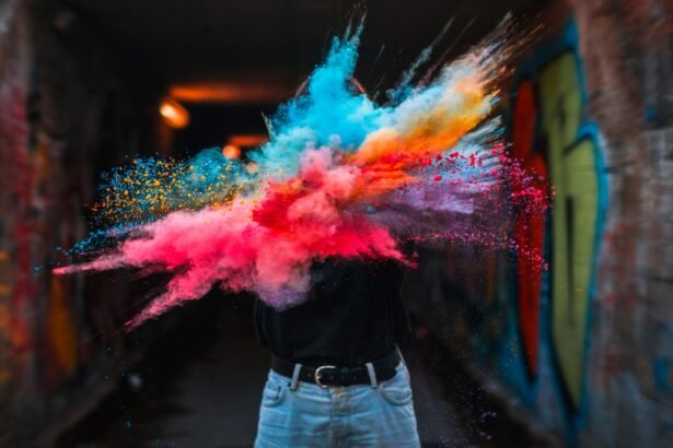 Vibrant powder explosion highlighting colorful creative expression with urban graffiti backdrop.
