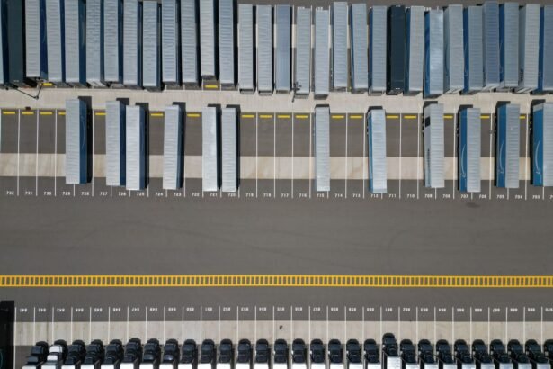 High-angle shot of trucks parked in an organized grid in an industrial parking lot.