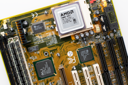 Close-up of a vintage AMD K6 CPU on a retro motherboard showing intricate electronic details.