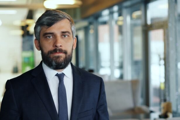 Professional businessman with a confident expression in a contemporary office environment.
