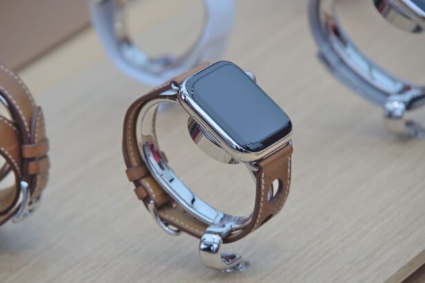 Close-up of a sleek smartwatch with a leather strap displayed on a wooden surface.
