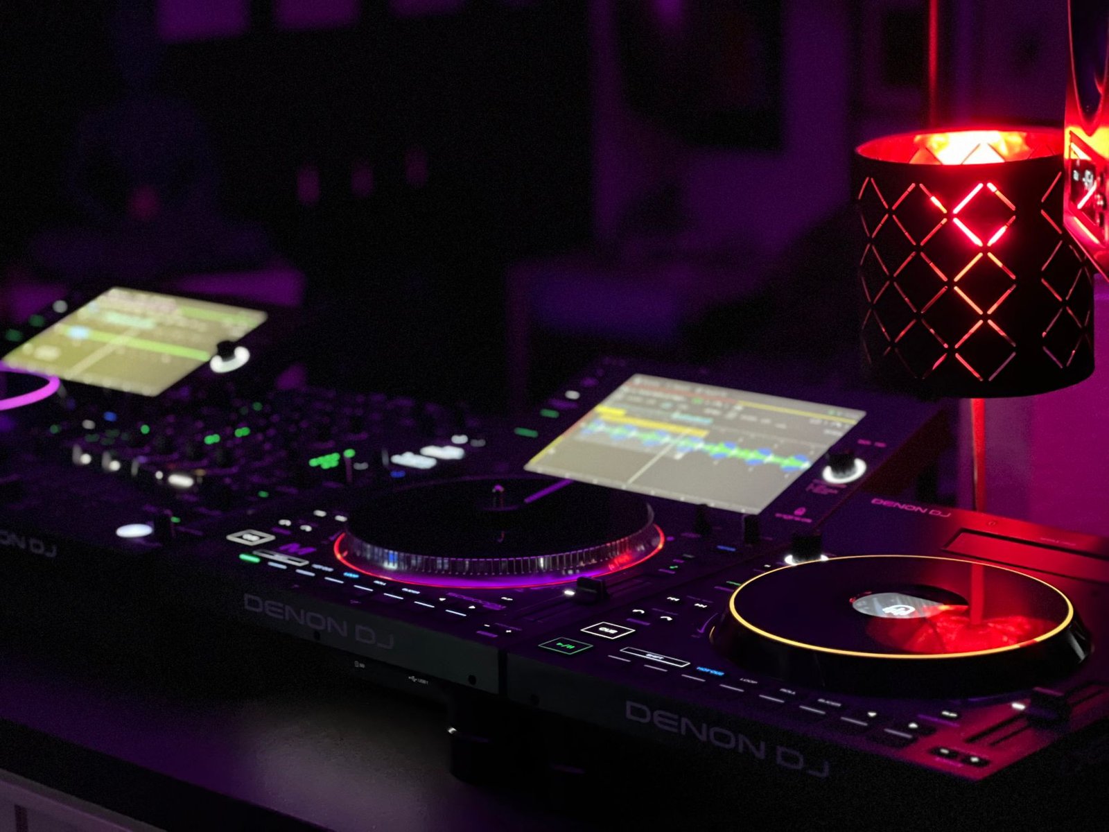 Close-up of a DJ mixing station with vibrant lights and sound equipment, perfect for music events.