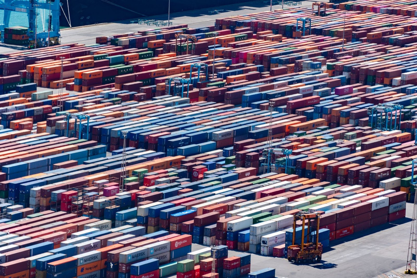 A bustling port with colorful cargo containers, aerial view showcasing global trade.