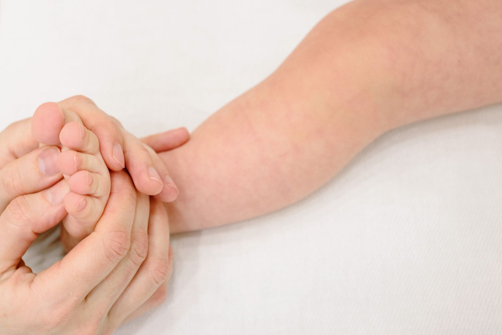 Tender infant foot massage providing soothing comfort and care.