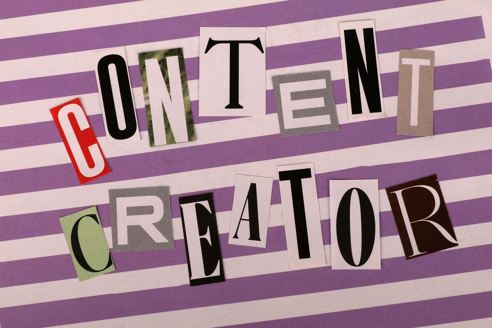 Artistic collage spelling 'Content Creator' using various fonts on a striped background.