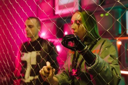 A cyberpunk-themed photo with two people and neon lights creates a futuristic ambiance.