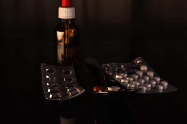 A collection of pharmaceuticals including pills and a bottle on a dark surface.