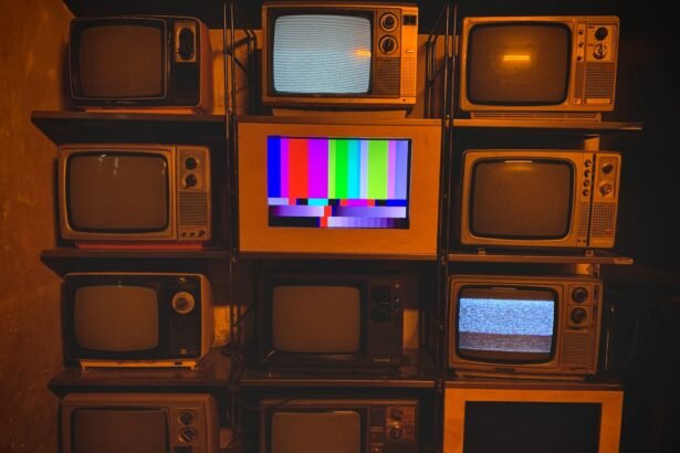 A collection of vintage televisions featuring static and color test patterns on the screens.