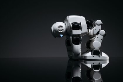 A modern robot toy depicted in a studio environment with its reflection visible on a dark surface.