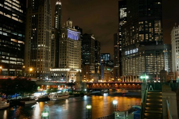 Illuminated Chicago skyscrapers and river at night with iconic bridge view.