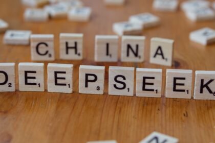 Close-up of wooden Scrabble tiles spelling 'China' and 'Deepseek' on a wooden surface.