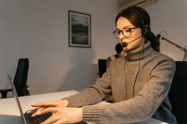 Woman in a call center providing customer support with a headset and laptop.