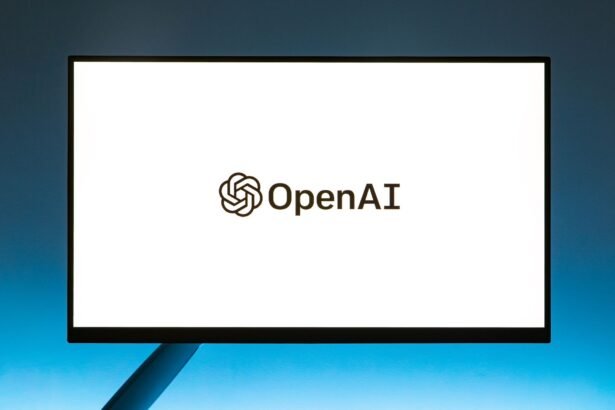 Minimalistic display of OpenAI logo on a monitor with a gradient blue background, representing modern technology.
