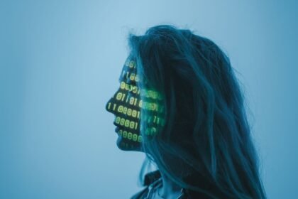 Silhouette of a woman with binary code projected on her face in a digital concept setting.