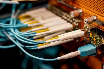 From above of optical switch equipment with many similar connectors with rubber cables and metal parts