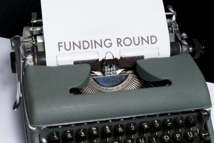 A vintage typewriter displaying the text 'Funding Round,' symbolizing investment and business planning.