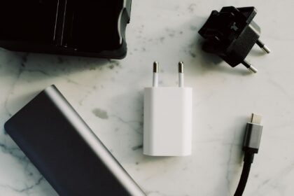 A collection of electronic adapters and chargers featuring USB-C and other connectors on a marble surface.