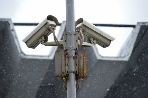 Close-up view of surveillance cameras during a snowfall in urban Москва setting.