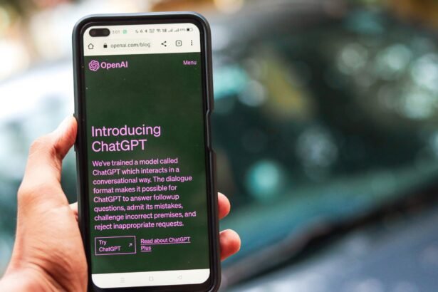 Close-up of a smartphone showing ChatGPT details on the OpenAI website, held by a person.