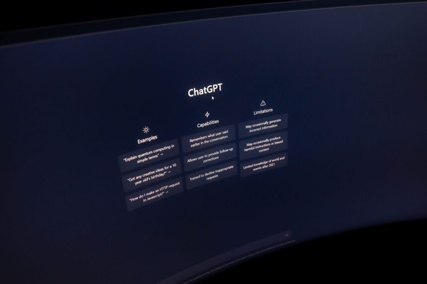 Close-up of a computer screen displaying ChatGPT interface in a dark setting.
