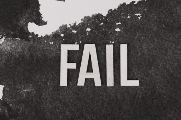 Grayscale image of the word 'FAIL' on a textured, monochrome background.