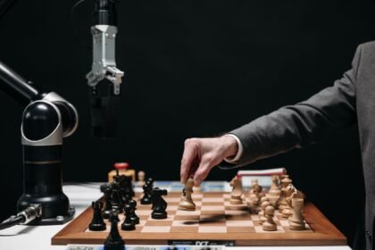 A robotic arm plays chess against a human, symbolizing AI innovation and strategy.