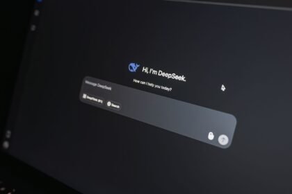 Close-up of DeepSeek AI chat interface on a laptop screen in low light.
